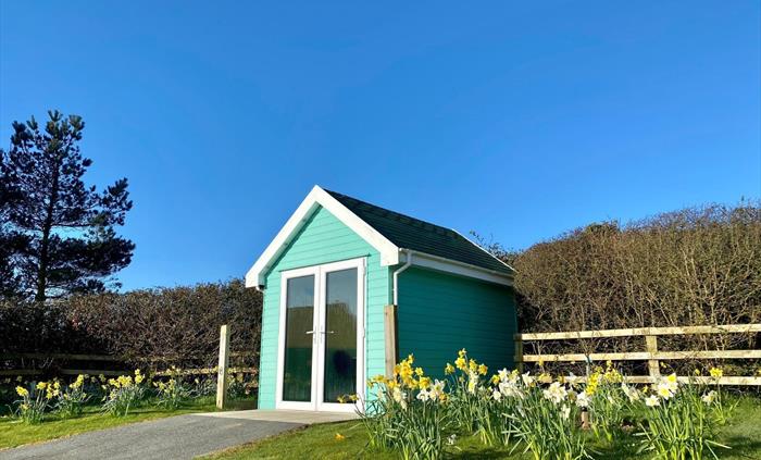 Beach Hut Dining Pods where guests can enjoy beverages and their take-aways